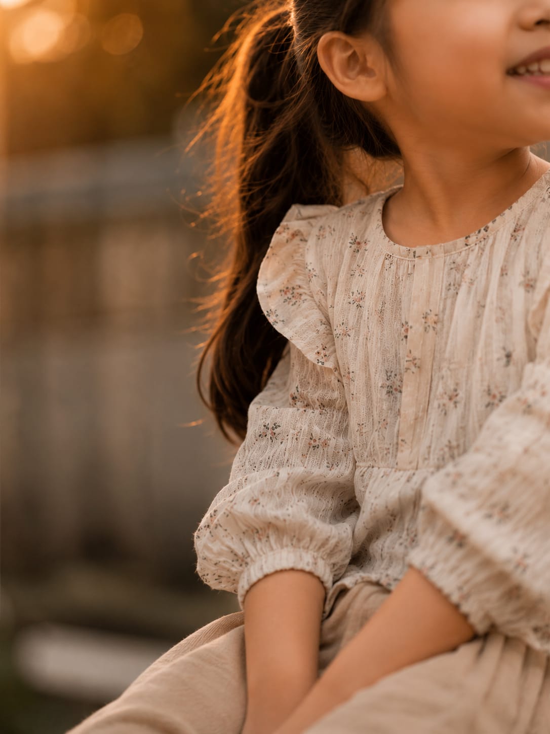 Roshana, a seven-year-old girl smiling in warm evening sunlight